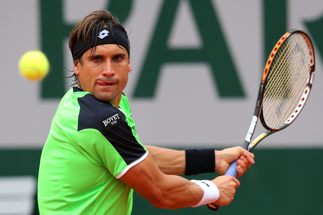 PARIS, FRANCE - MAY 31: David Ferrer of Spain plays a backhand during his Men's Singles match against Feliciano Lopez of Spain on day six of the French Open at Roland Garros on May 31, 2013 in Paris, France. (Photo by Julian Finney/Getty Images)