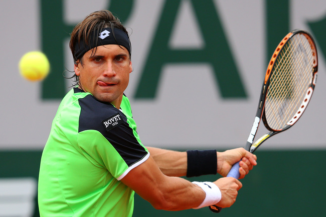 PARIS, FRANCE - MAY 31:  David Ferrer of Spain plays a backhand during his Men's Singles match against Feliciano Lopez of Spain on day six of the French Open at Roland Garros on May 31, 2013 in Paris, France.  (Photo by Julian Finney/Getty Images)