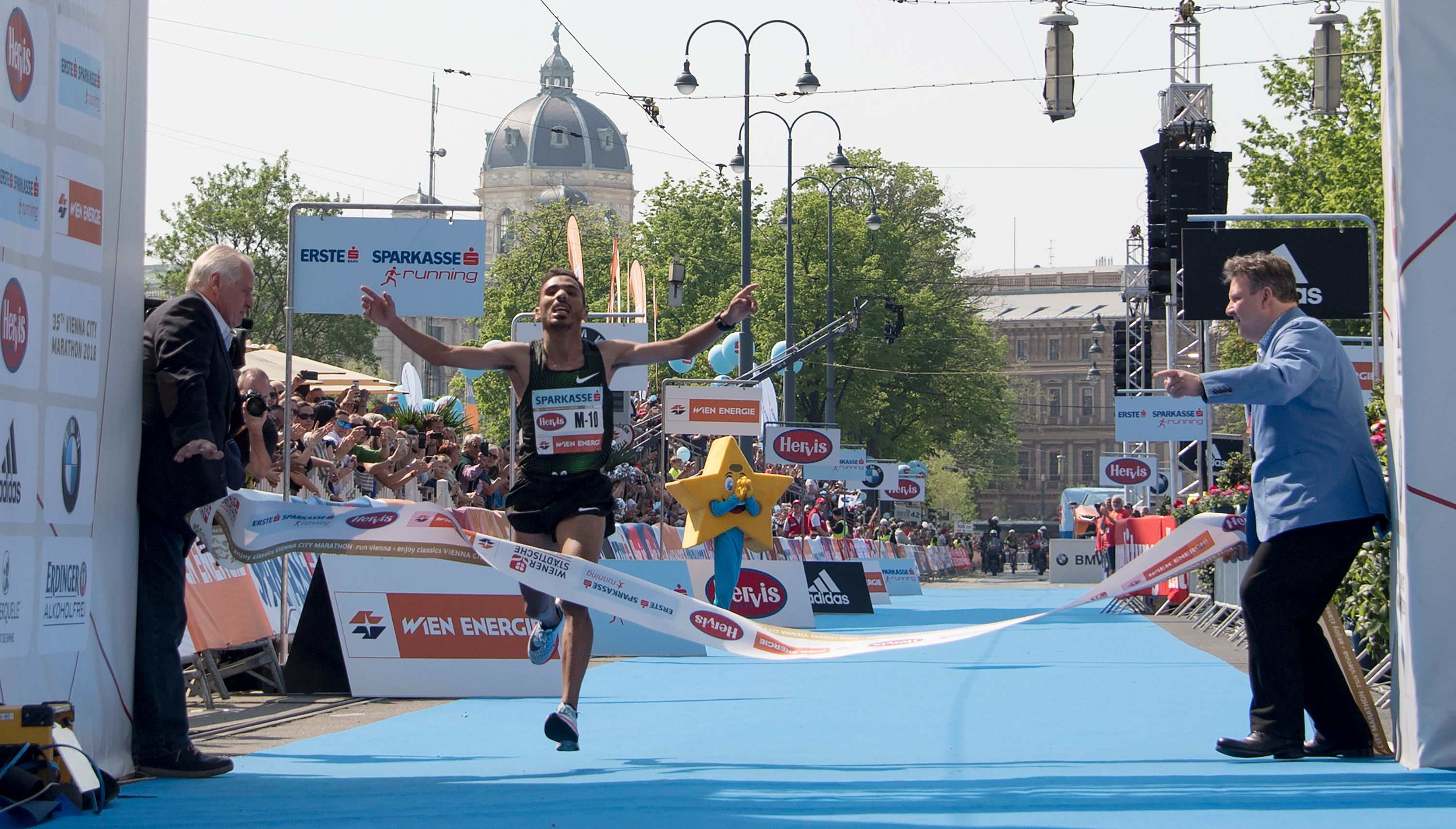 Salah-Eddine Bounasr of Morocco reacts as he crosses the finish of the Vienna City Marathon in Vienna, Austria, on April 22, 2018.  More than 41000 athletes take part in the 35th Vienna City Marathon. / AFP PHOTO / JOE KLAMAR